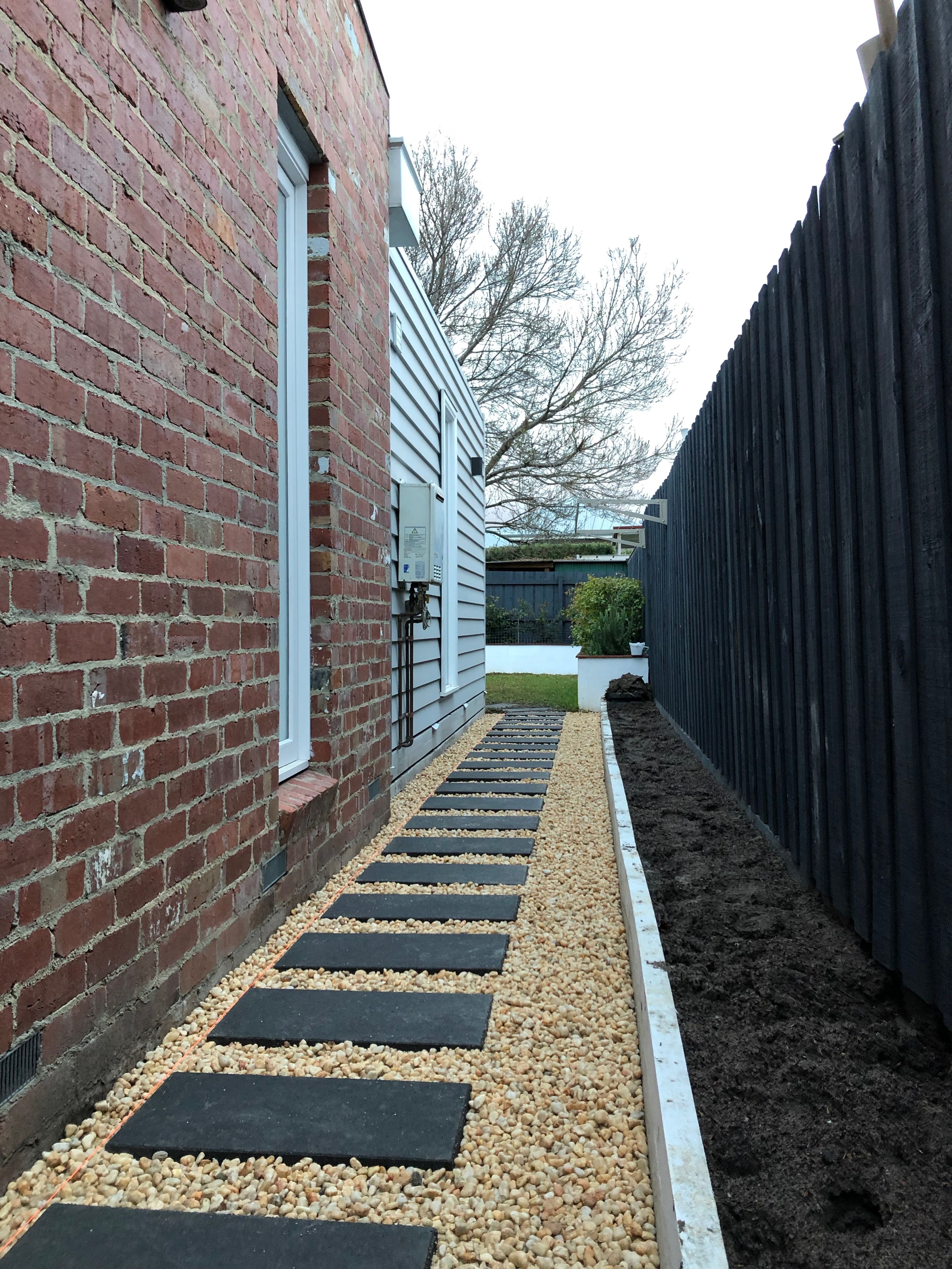 Pavers &amp; pebbles with a bike shelter mak Bunnings 